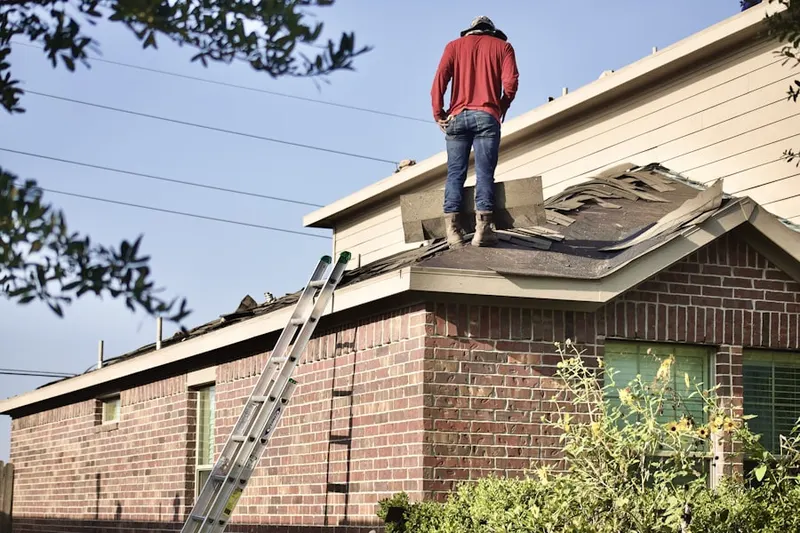 Professional roofer working on a residential roof in California Polytechnic State University